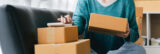 Woman managing shipping and finances for her small business